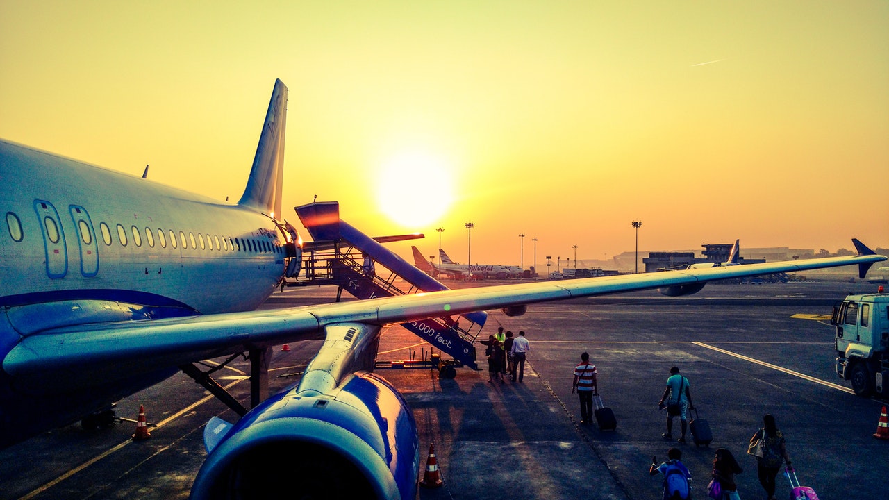 Aircraft loading passengers against a sunrise