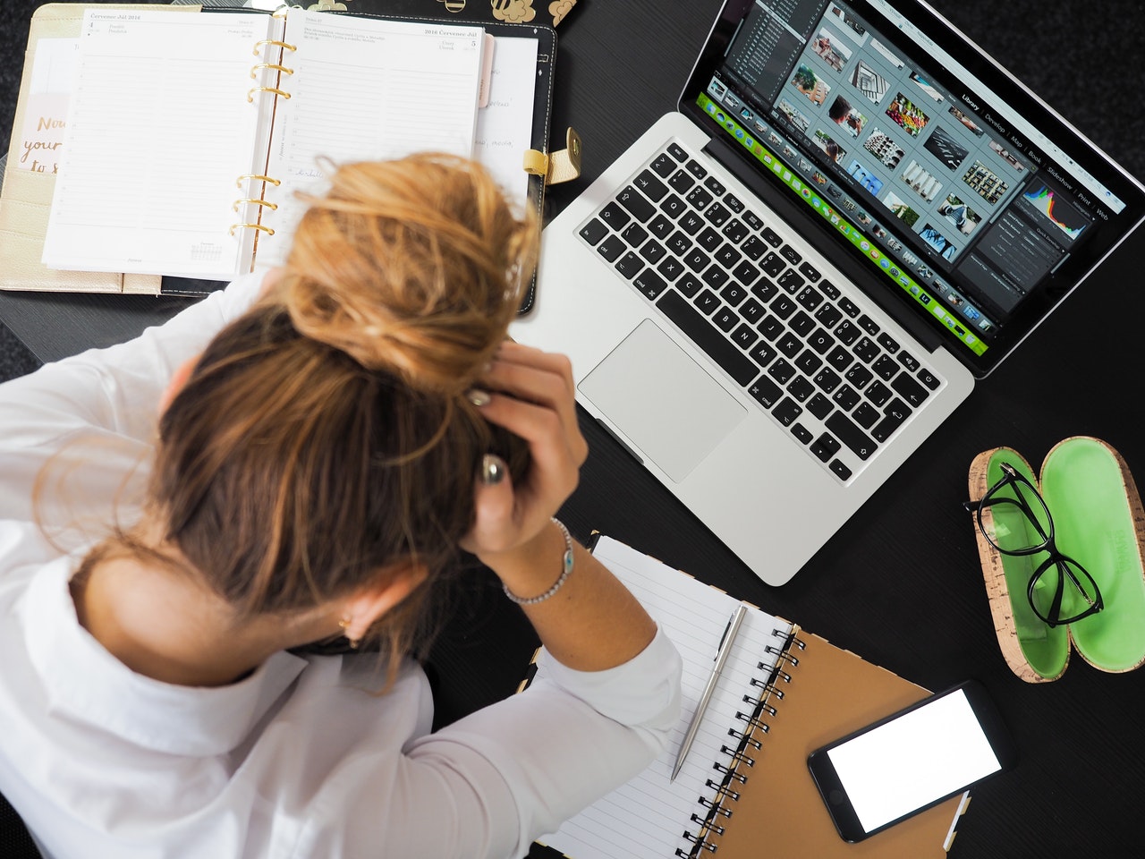 Unemployed lady grasps hair in frustration