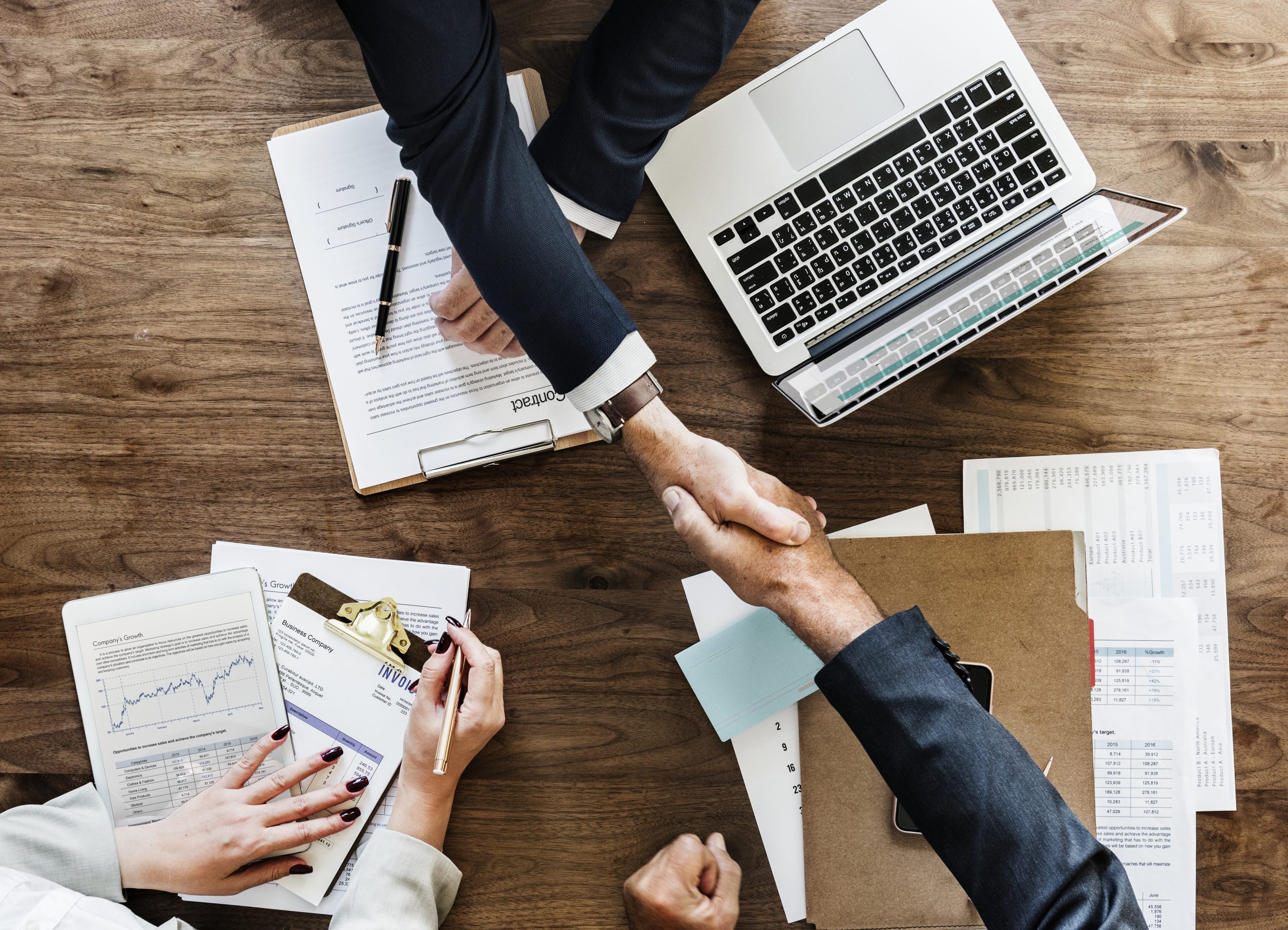 Agreement business desk hand shake