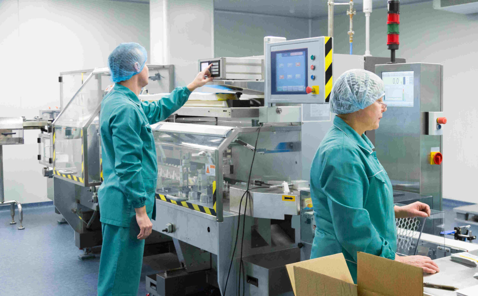 Pharmaceutical factory workers in sterile environment